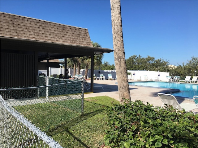 exterior space featuring ceiling fan, a community pool, and a patio area