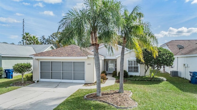 ranch-style house featuring a garage, cooling unit, and a front lawn