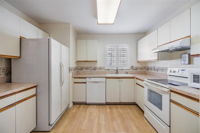 kitchen with white cabinets, white appliances, sink, and light wood-type flooring