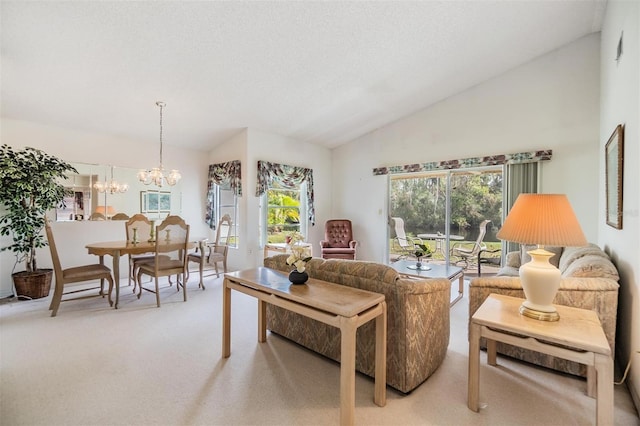 living room with high vaulted ceiling, light colored carpet, and an inviting chandelier