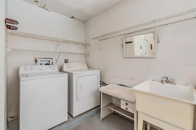 laundry room featuring electric panel, washer and dryer, and sink