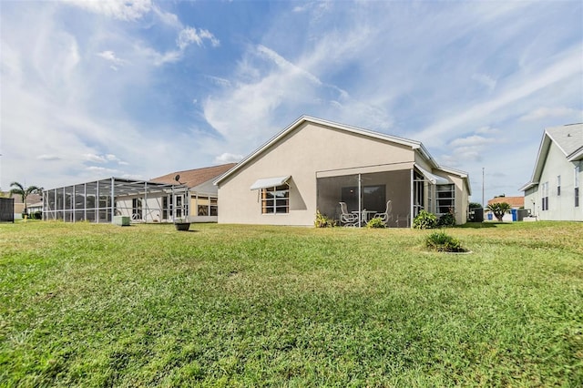 4222 Northampton Dr, New Port Richey, FL 34653 - rear view of house with stucco siding, a lawn, and a sunroom