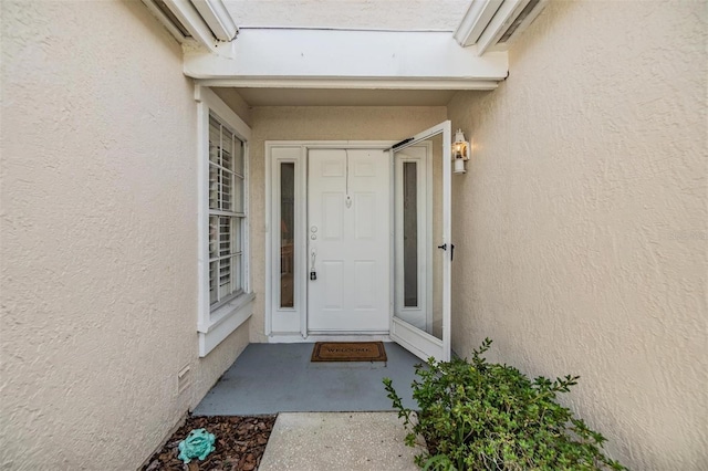 4222 Northampton Dr, New Port Richey, FL 34653 - doorway to property with stucco siding
