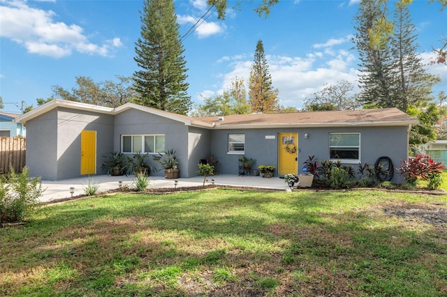 ranch-style home featuring a front yard