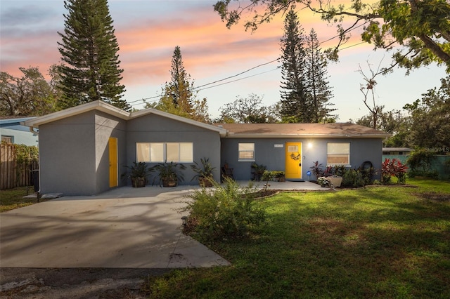 ranch-style house with a lawn