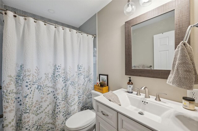 bathroom with vanity, toilet, and a shower with shower curtain