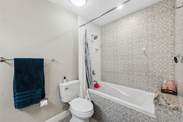 bathroom with toilet, shower / bath combo with shower curtain, and a textured ceiling