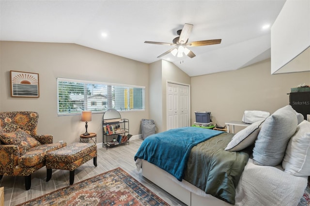 bedroom with a closet, vaulted ceiling, ceiling fan, and light hardwood / wood-style flooring