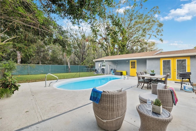 view of pool with a lawn and a patio area