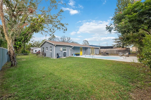 rear view of property with a patio and a yard