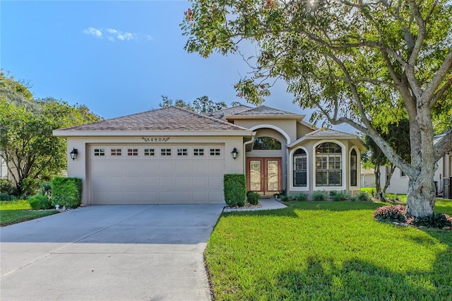 view of front facade with a front lawn and a garage