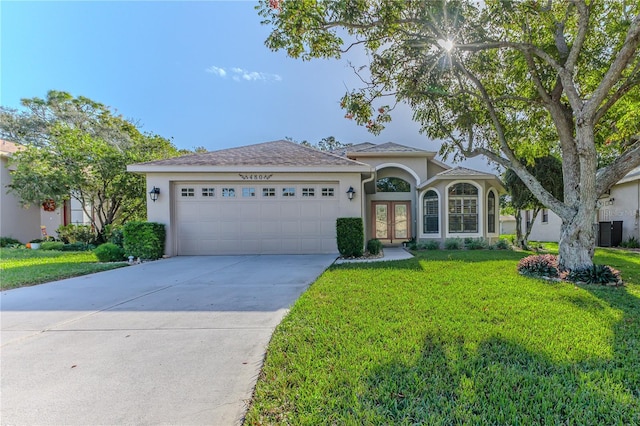 view of front of home with a garage and a front yard