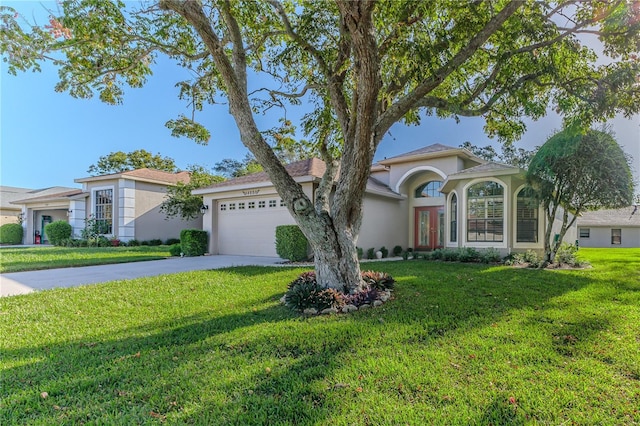 view of front of property with a garage and a front yard