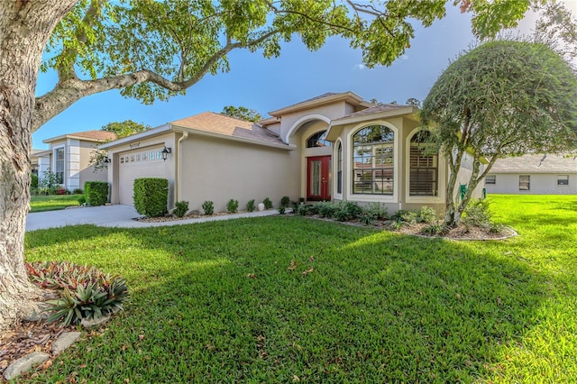 mediterranean / spanish-style house with a garage and a front yard