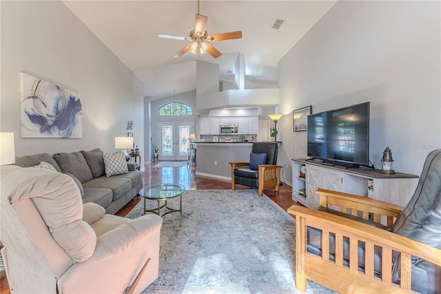 living room featuring french doors, hardwood / wood-style floors, ceiling fan, and high vaulted ceiling