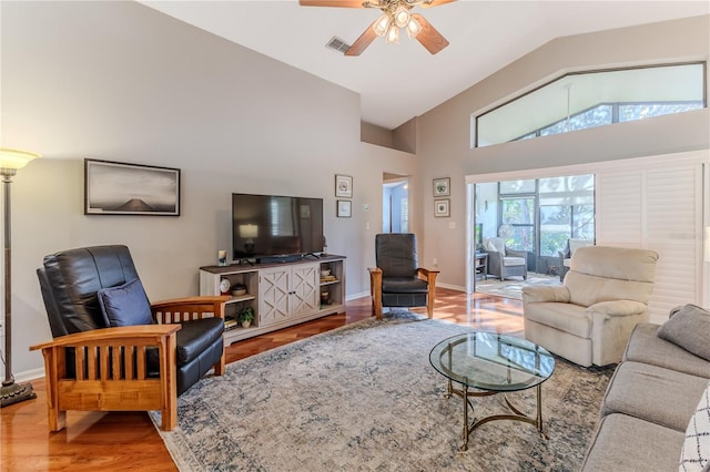 living room featuring high vaulted ceiling, hardwood / wood-style flooring, and ceiling fan