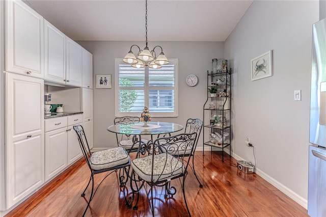 dining room featuring light hardwood / wood-style floors and a chandelier