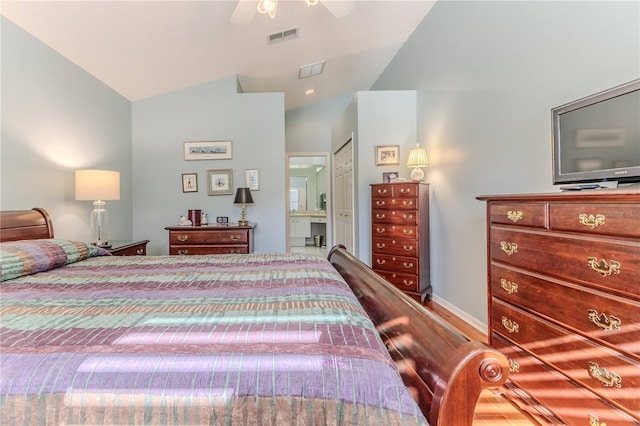 bedroom featuring ensuite bath, lofted ceiling, ceiling fan, and wood-type flooring