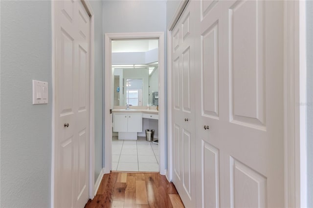 hallway featuring light hardwood / wood-style floors and sink