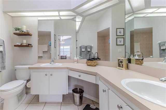 bathroom featuring toilet, vanity, and tile patterned flooring