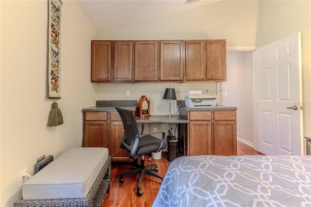 bedroom featuring dark hardwood / wood-style flooring and vaulted ceiling