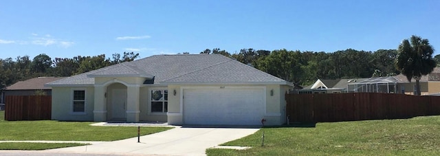 view of front of house featuring a garage and a front lawn