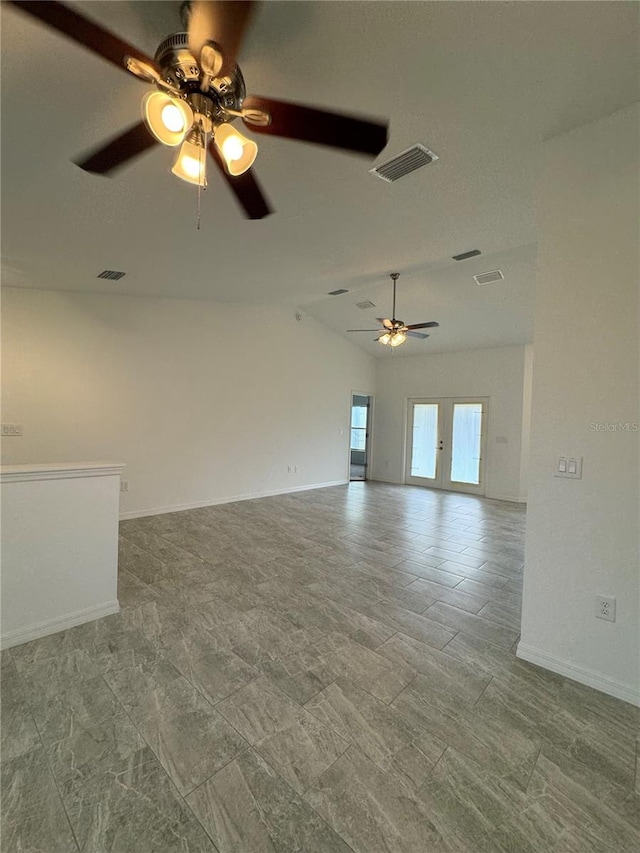 empty room with french doors and vaulted ceiling