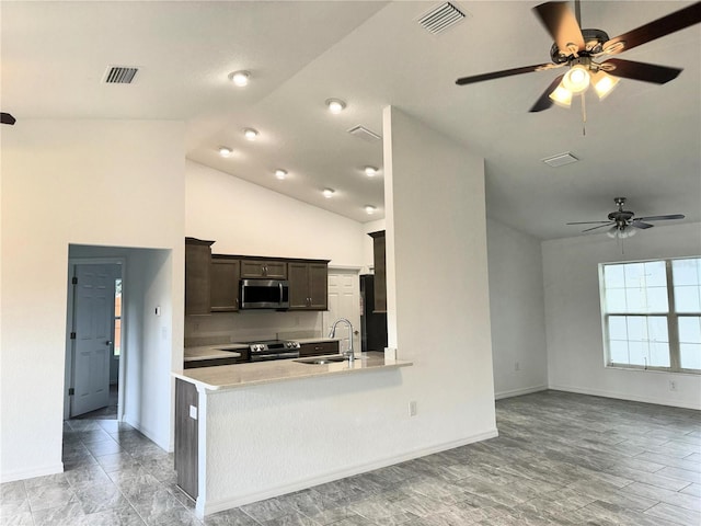 kitchen with sink, stainless steel appliances, light hardwood / wood-style flooring, kitchen peninsula, and vaulted ceiling