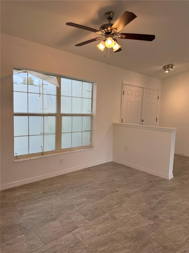 unfurnished room with ceiling fan