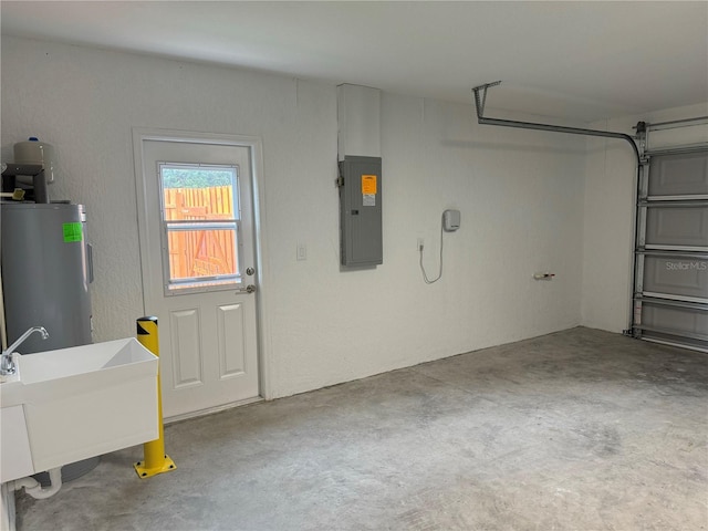 garage featuring electric water heater, electric panel, and sink