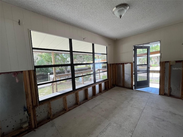 unfurnished room featuring a textured ceiling