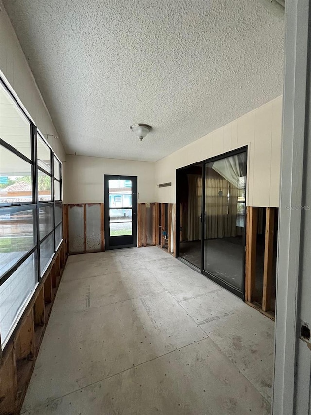 unfurnished room featuring a textured ceiling