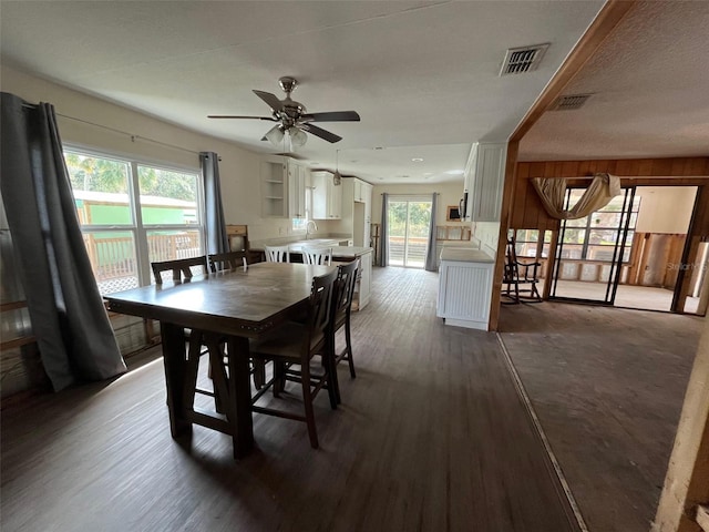 dining room featuring dark wood-style floors and a ceiling fan