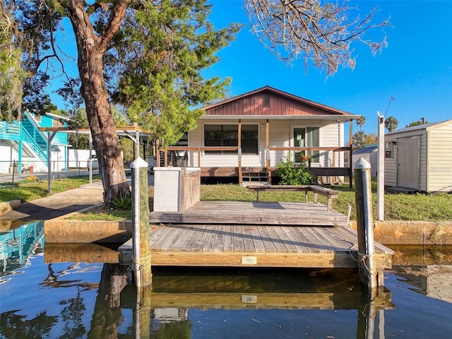 back of property featuring a shed, an outbuilding, and fence