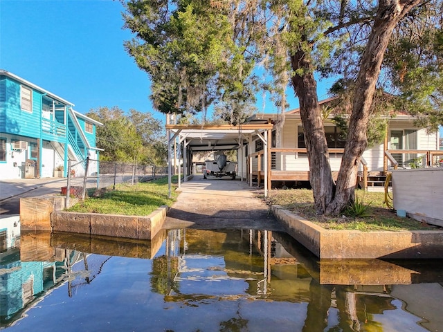 back of property featuring a water view