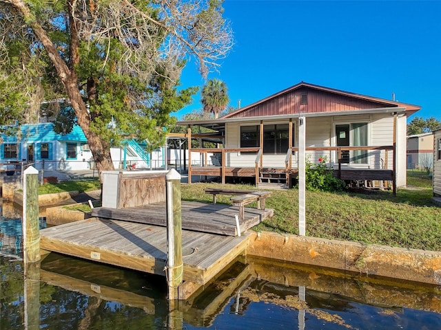 dock with a water view and a lawn