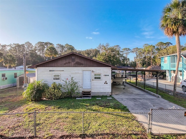 view of outbuilding featuring entry steps, driveway, and an attached carport