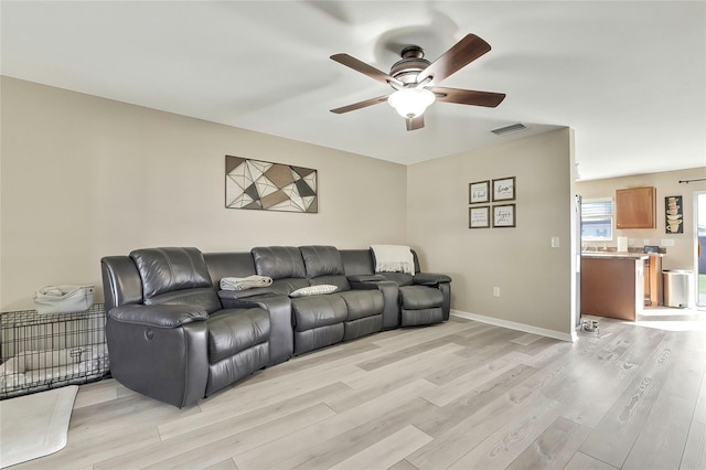 living room with ceiling fan and light hardwood / wood-style floors