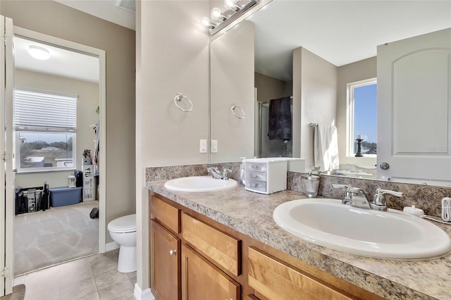 bathroom with tile patterned floors, vanity, and toilet