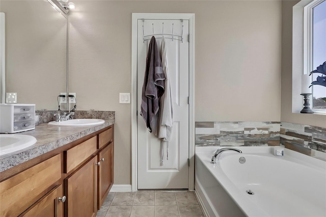 bathroom featuring tile patterned floors, vanity, and a tub to relax in