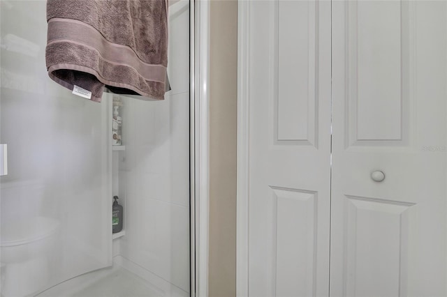 bathroom with a shower with door