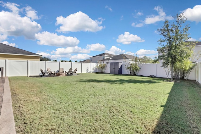 view of yard featuring a fire pit and a storage unit