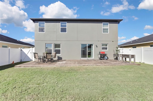 back of house with a yard and a patio area