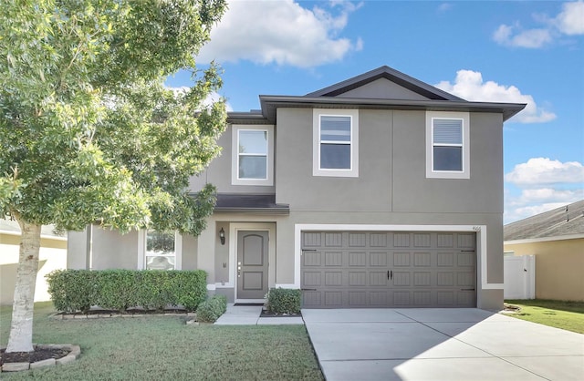 view of front of property featuring a front yard and a garage