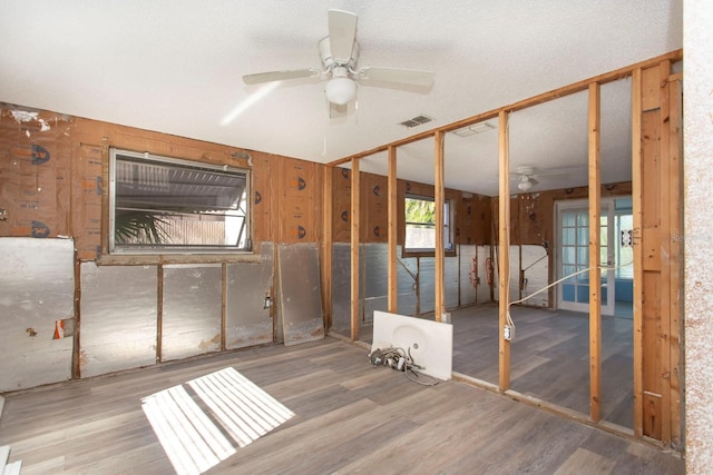 interior space with wood-type flooring and ceiling fan