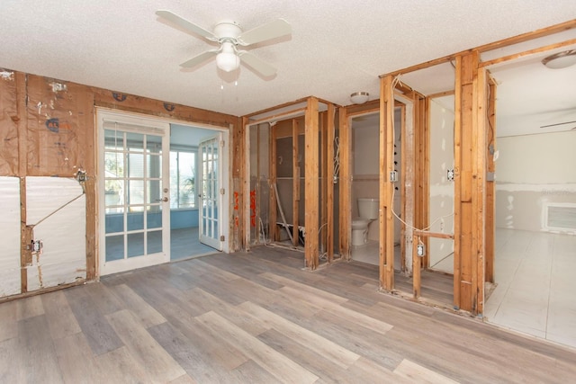 misc room featuring hardwood / wood-style floors, a textured ceiling, and ceiling fan