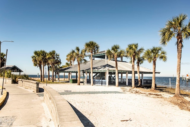 surrounding community with a gazebo and a water view