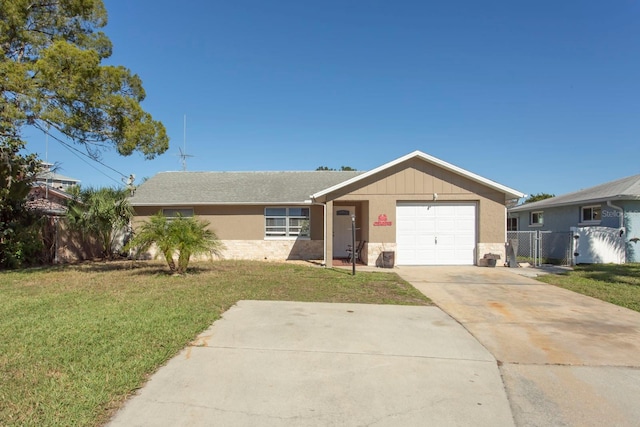 ranch-style home featuring a front yard and a garage