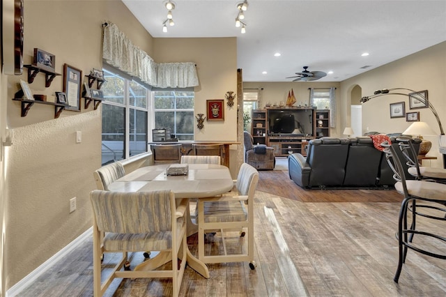 dining space with light hardwood / wood-style floors and ceiling fan