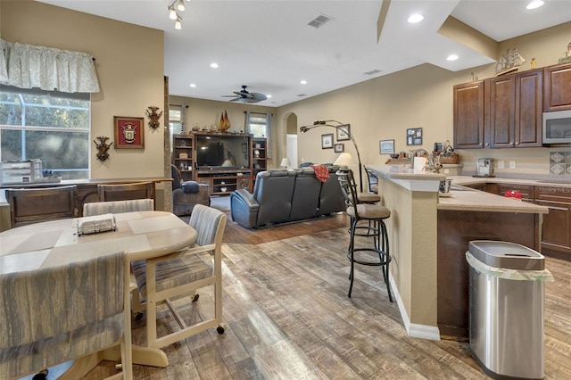 dining space featuring light hardwood / wood-style flooring and ceiling fan